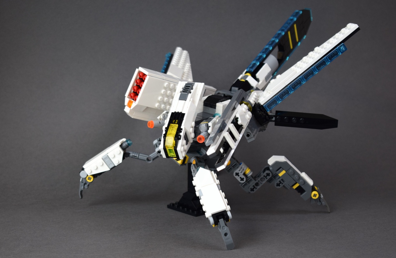 The Dragonfly mech is built on a frame resembling its namesake insect. It is quarupedal, with a pronounced head, short thorax, and an elongated blade shaped abdomen. Two small cannons are attached to the underside of the head. The vehicle also has two wings, each of which has a heavy weapon attached. One wing is built around a large missile battery that can fire eight warheads at once. The other wing carries a split barrel railgun that is almost as long as the rest of the mech.